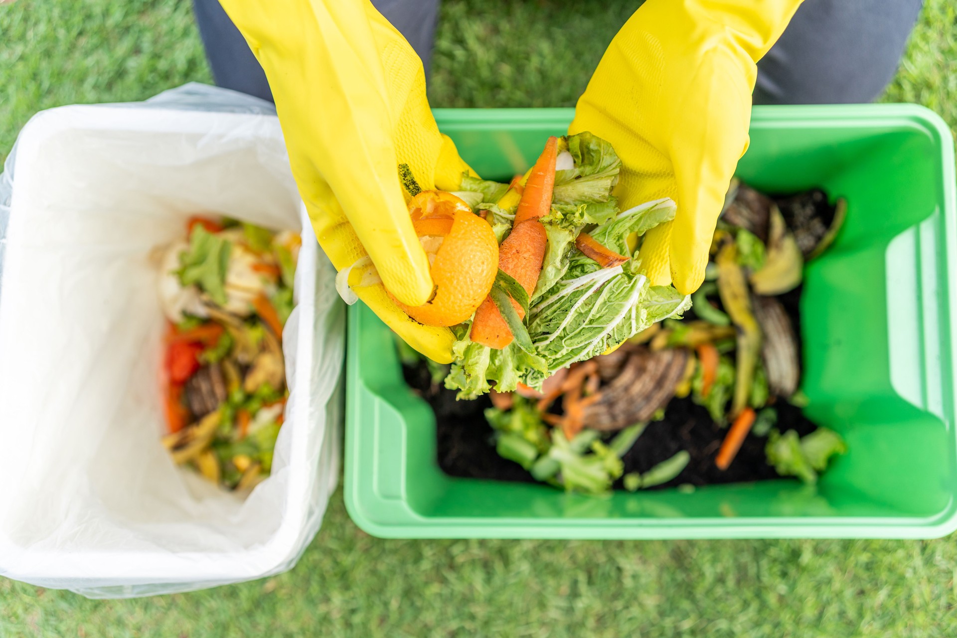 Ecology compost supply Kitchen waste recycling composter environmentally friendly. The young man throws leftover fruit peel egg shell and vegetables reduce waste